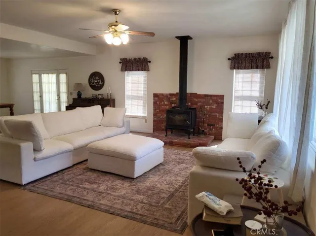 a living room with furniture chandelier and a window