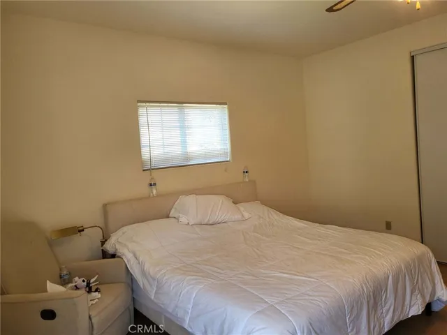a bedroom with a bed and window
