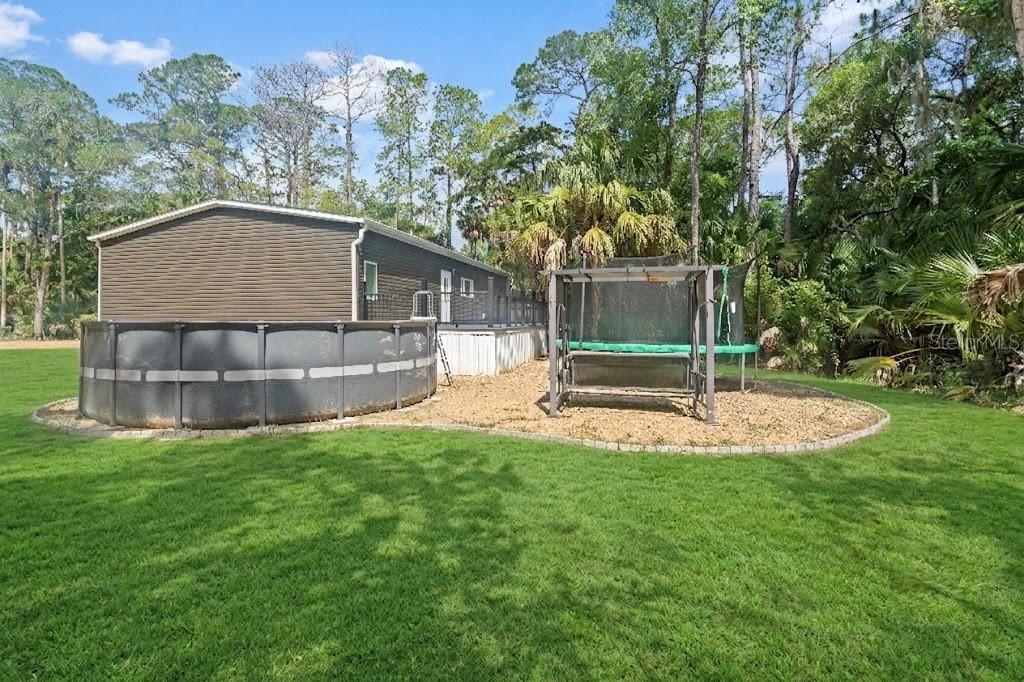 375 Sapp Street Inglis, FL 34449 - Photo 36 of 36 a view of a house with a backyard and a patio