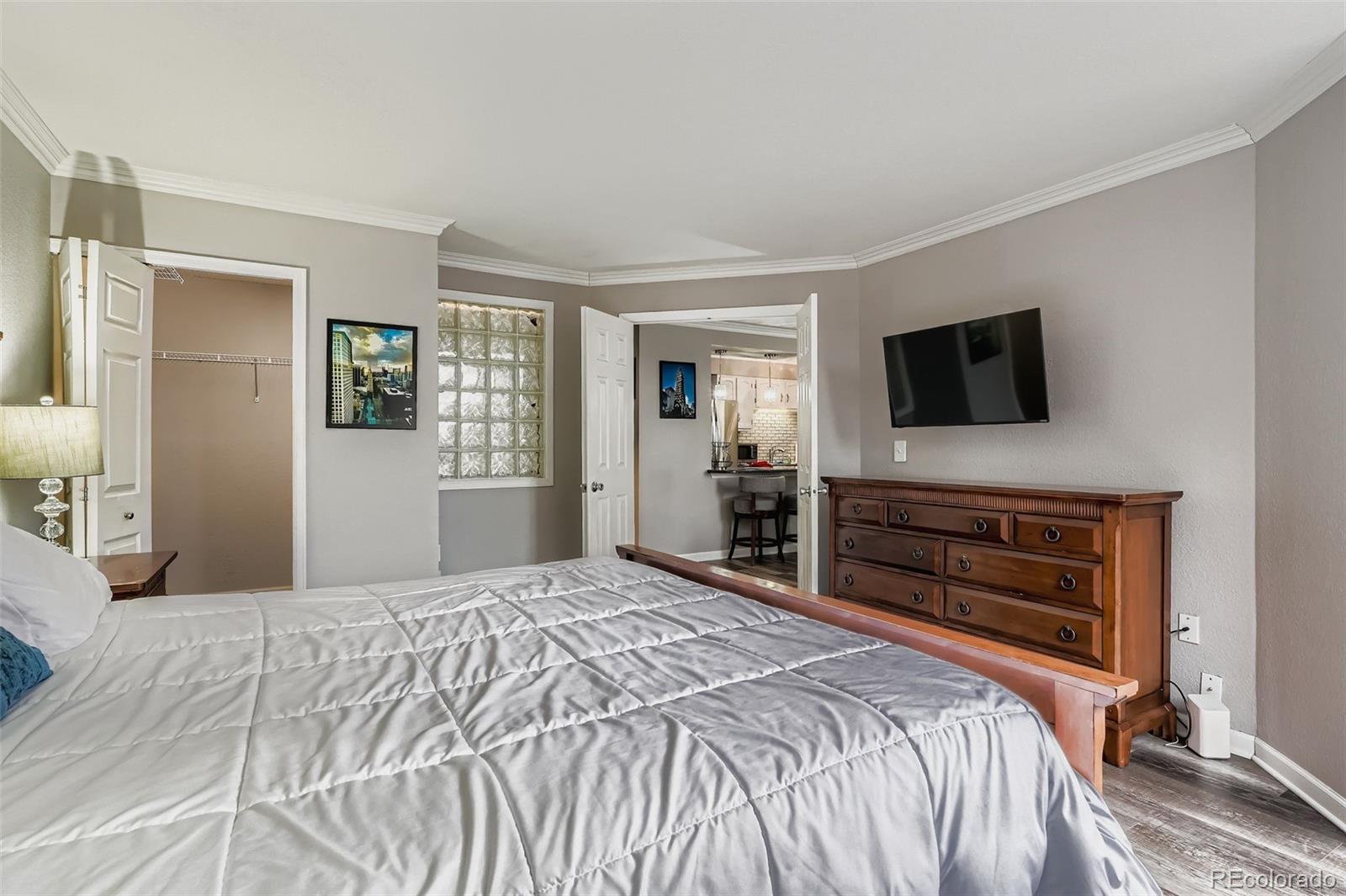 1625 Larimer Street, Unit 602 Denver, CO 80202 - Photo 11 of 22 a bedroom with a bed and a flat screen tv
