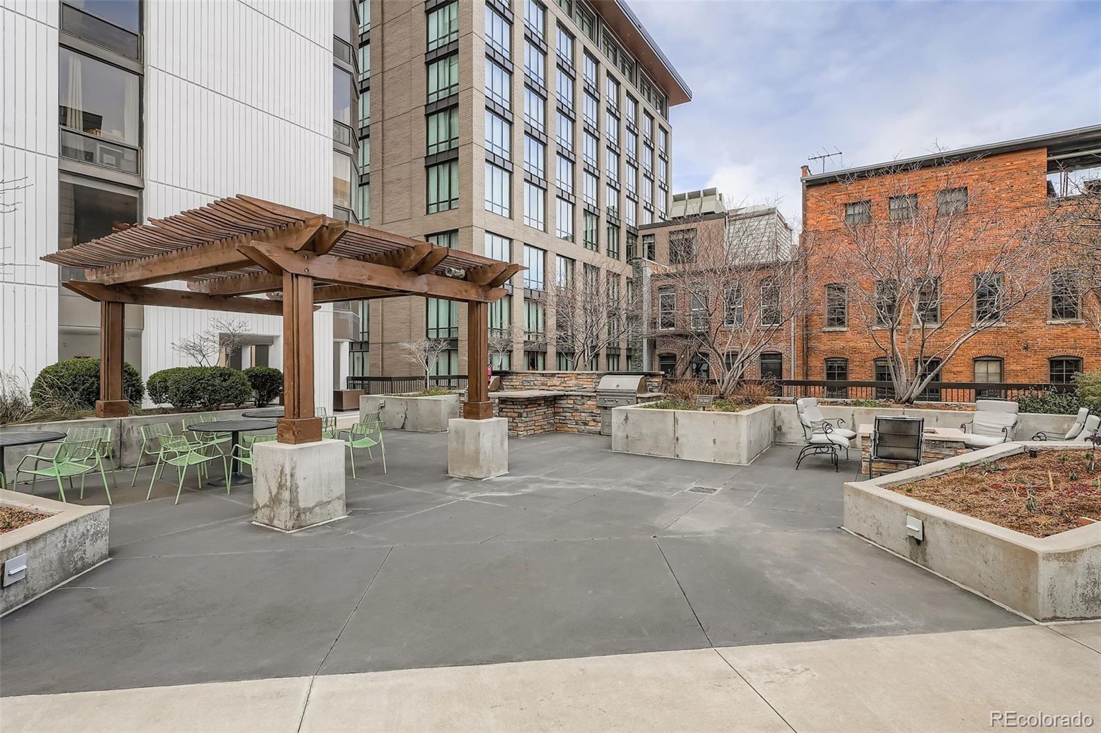 1625 Larimer Street, Unit 602 Denver, CO 80202 - Photo 19 of 22 a view of a patio with couches and table and chairs