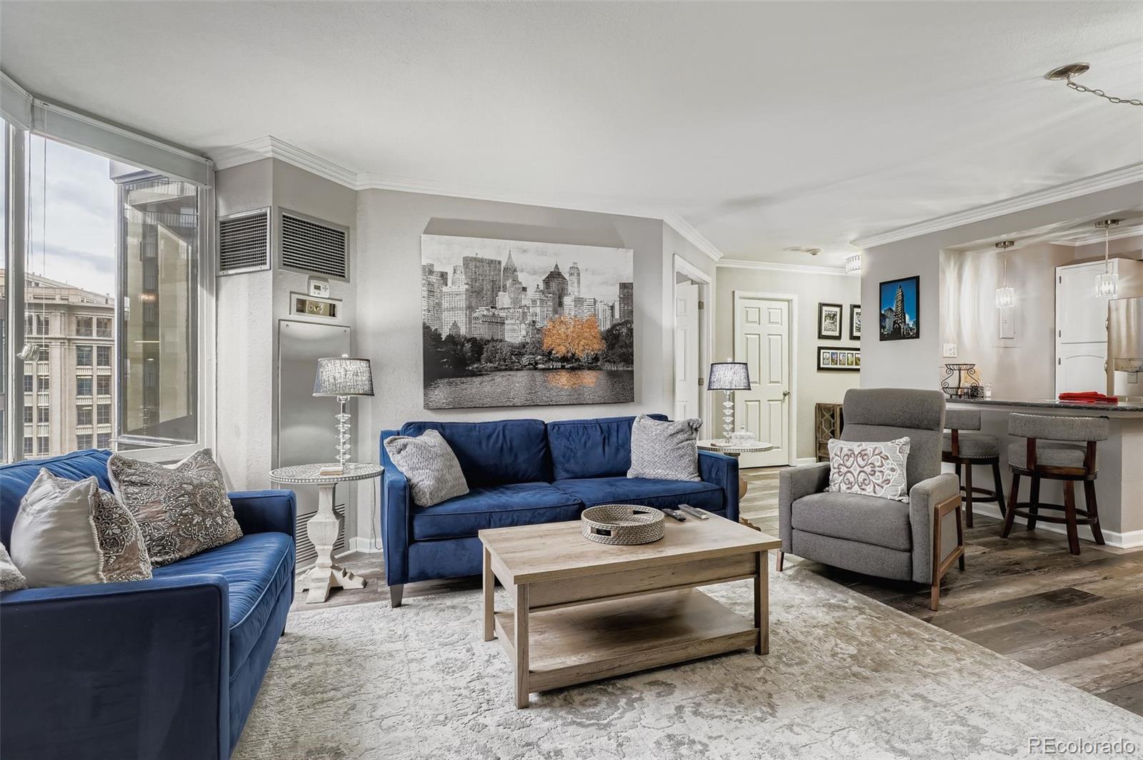 1625 Larimer Street, Unit 602 Denver, CO 80202 - Photo 2 of 22 a living room with furniture and a large window