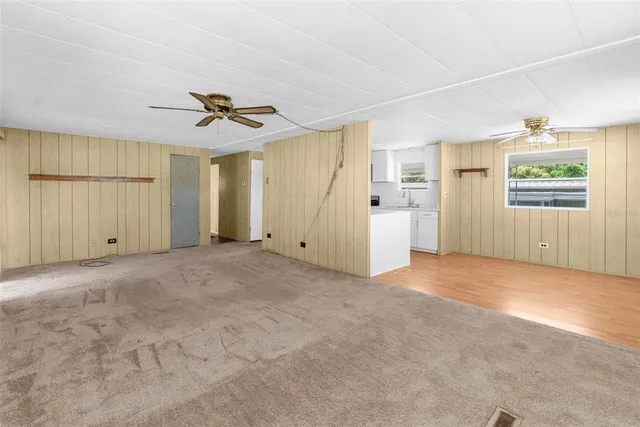 a view of a bedroom with a chandelier fan and closet area