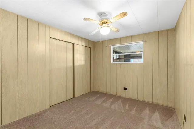 a view of a room with a chandelier fan