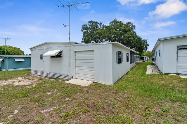 a backyard of a house with table and chairs