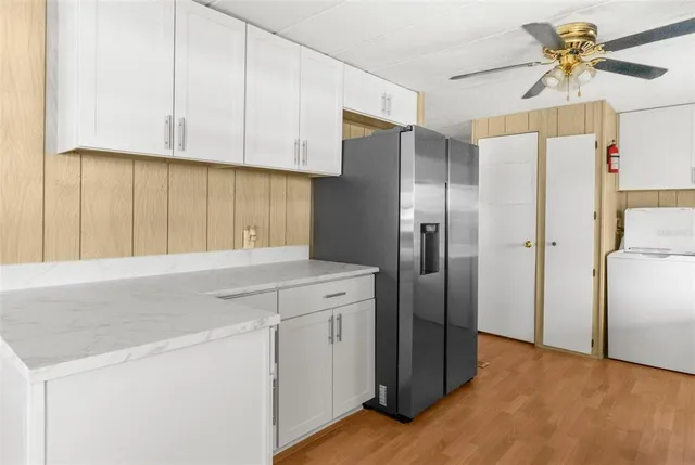 a kitchen with stainless steel appliances a refrigerator sink and cabinets