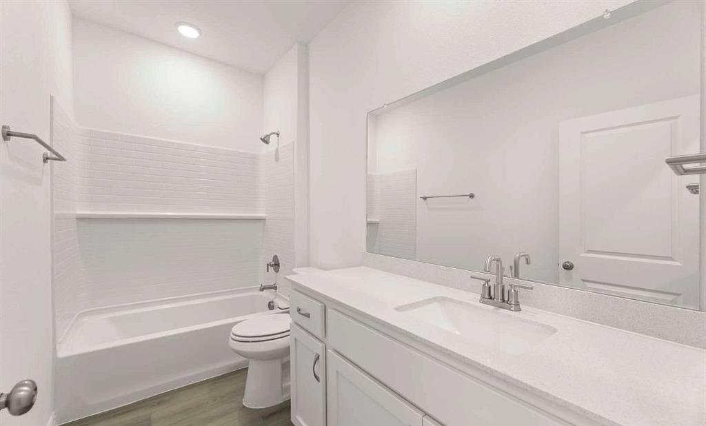 633 Blue Rdg Drive Mansfield, TX 76063 - Photo 17 of 17 a bathroom with a granite countertop sink a toilet and a bathtub
