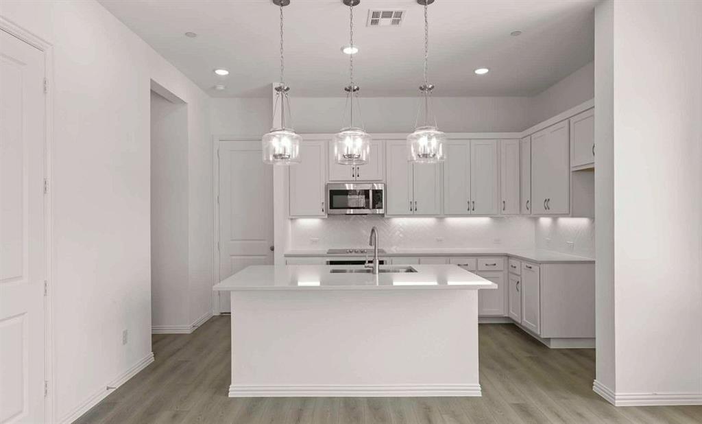 633 Blue Rdg Drive Mansfield, TX 76063 - Photo 4 of 17 a view of kitchen with kitchen island stainless steel appliances a sink and cabinets