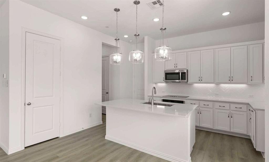 633 Blue Rdg Drive Mansfield, TX 76063 - Photo 5 of 17 a kitchen with kitchen island a sink stainless steel appliances and cabinets