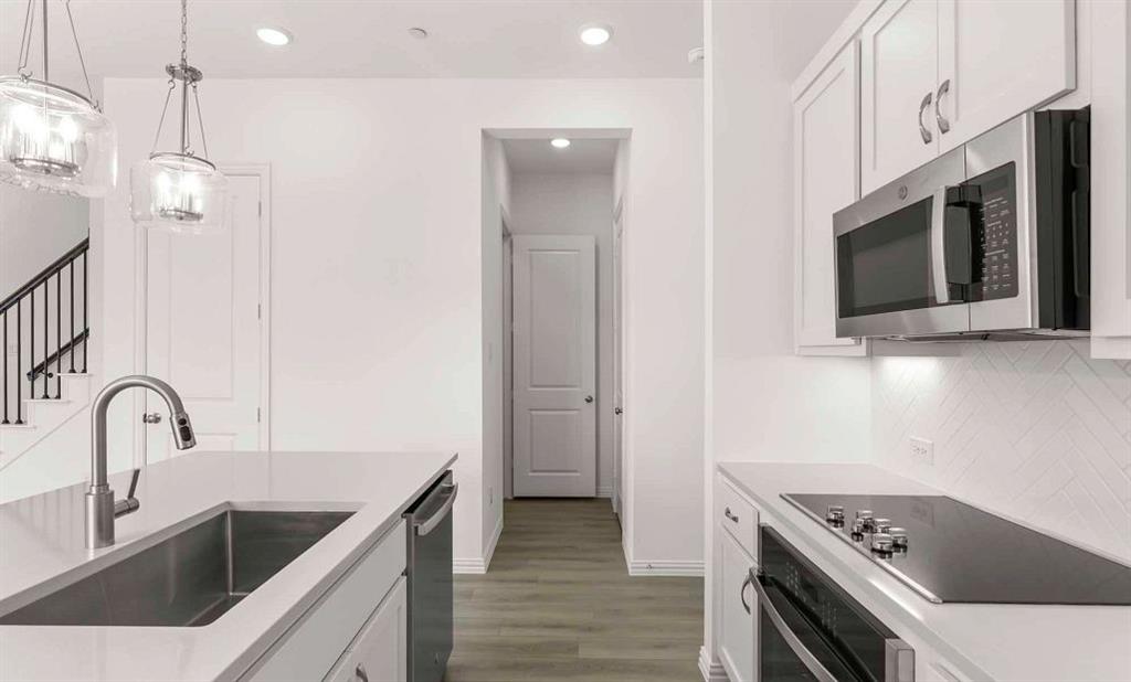 633 Blue Rdg Drive Mansfield, TX 76063 - Photo 6 of 17 a kitchen with a sink cabinets and stainless steel appliances