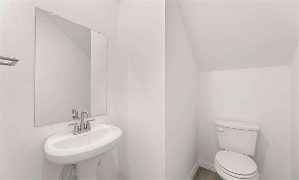 633 Blue Rdg Drive Mansfield, TX 76063 - Photo 7 of 17 a bathroom with a sink a toilet and mirror