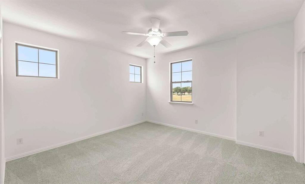633 Blue Rdg Drive Mansfield, TX 76063 - Photo 9 of 17 an empty room with windows and chandelier fan