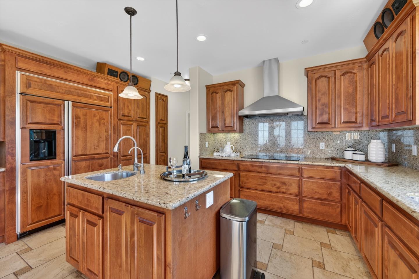 17599 Montebello Road Cupertino, CA 95014 - Photo 24 of 83 a kitchen with stainless steel appliances granite countertop a sink a stove and a wooden cabinets