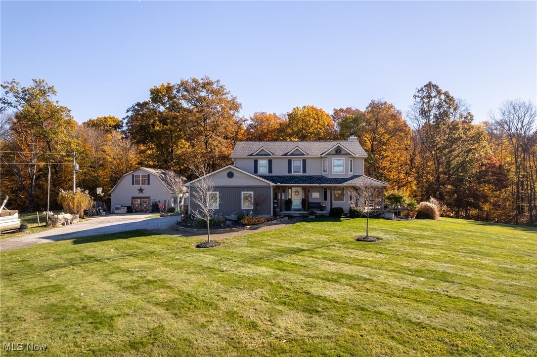 11827 Stratton Road West Salem, OH 44287 - Photo 2 of 47 View of front of house with a porch, a front yard, and driveway