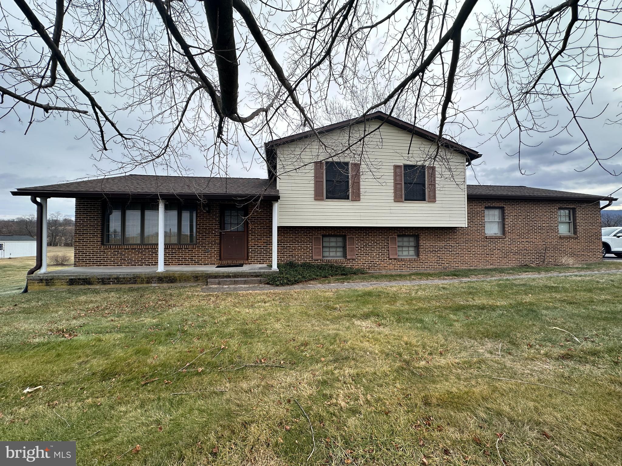 12103 Itnyre Road Smithsburg, MD 21783 - Photo 4 of 84 a front view of a house with a garden and yard