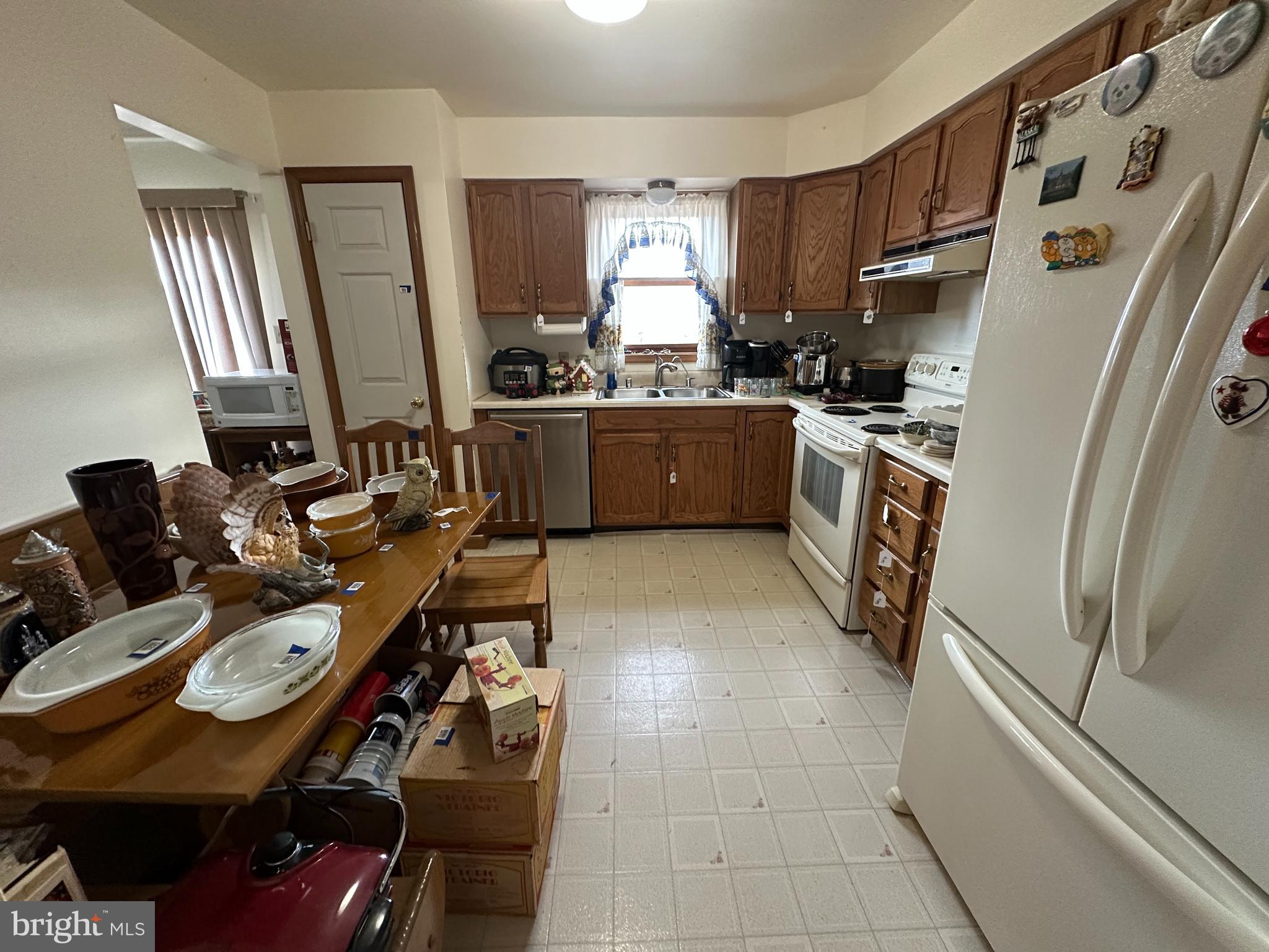 12103 Itnyre Road Smithsburg, MD 21783 - Photo 44 of 84 a kitchen with stainless steel appliances a refrigerator a sink a stove and white cabinets