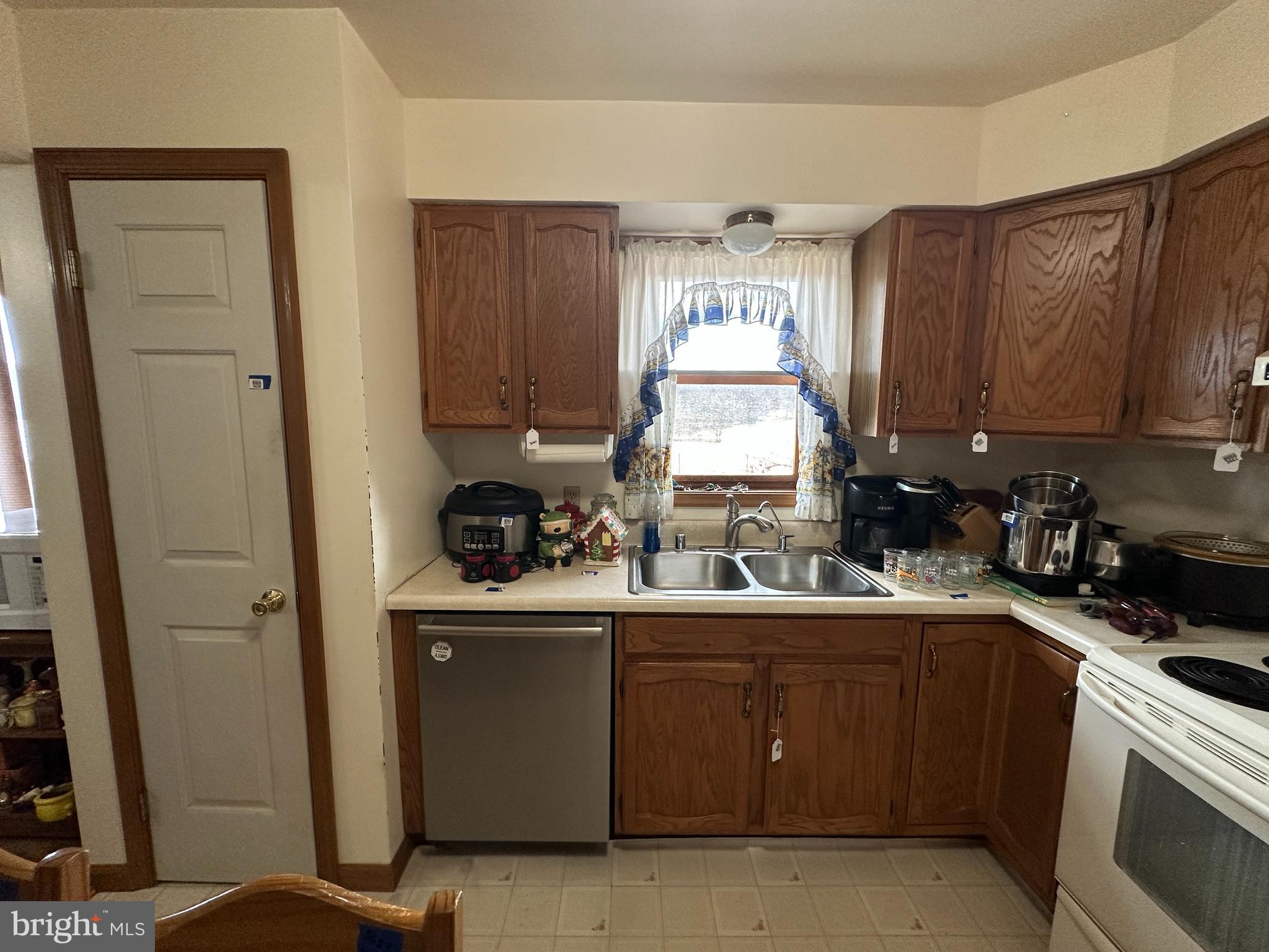 12103 Itnyre Road Smithsburg, MD 21783 - Photo 46 of 84 a kitchen with a sink a stove cabinets and a window