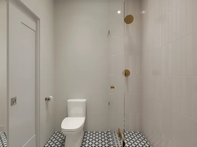 a bathroom with a toilet and a shower