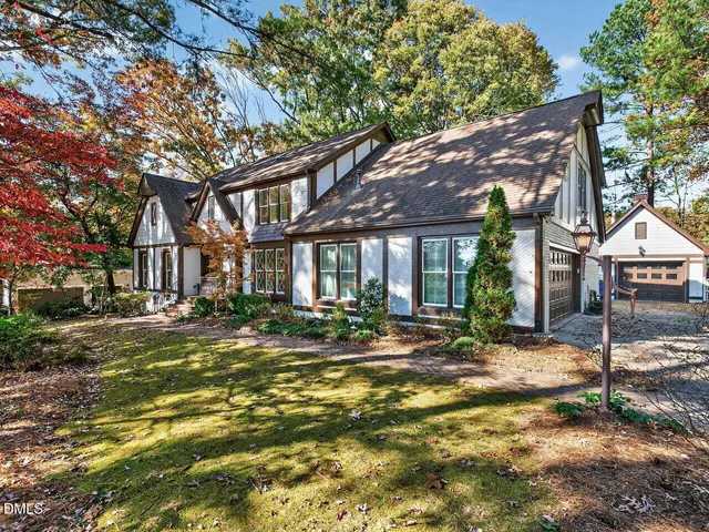 a view of a house with backyard and sitting area