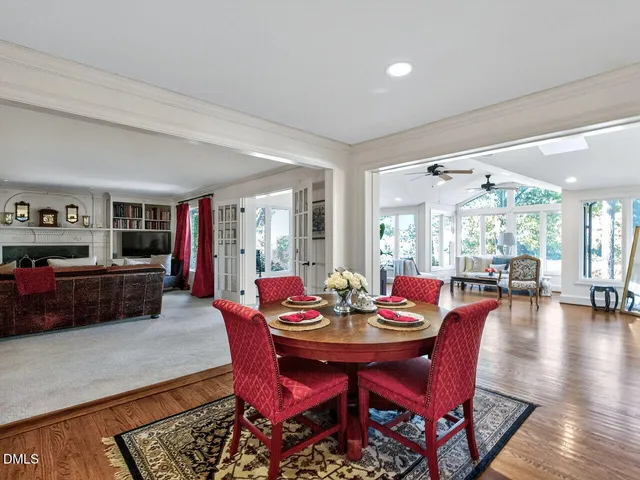 a kitchen with kitchen island granite countertop stainless steel appliances a sink dishwasher a microwave oven a stove with wooden cabinets and floor