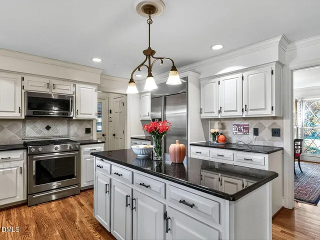 a kitchen with granite countertop a sink a stove and microwave