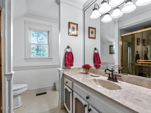 a living room with furniture a fireplace and a large window