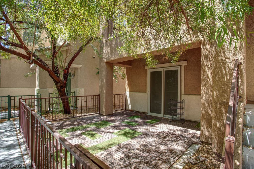 7724 Vibrant Thread Court Las Vegas, NV 89149 - Photo 38 of 43 A private outdoor space with durable brick pavers offers serene moments under a shaded canopy.