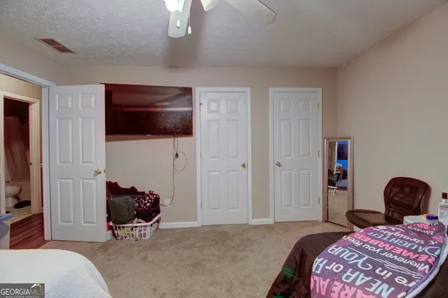 a bedroom with a bed and a chair