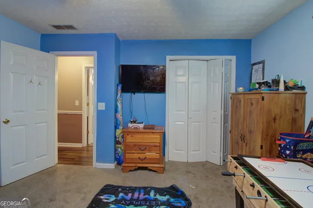 a bedroom with a bed and a flat screen tv