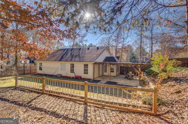 a view of a house with large trees in front of it