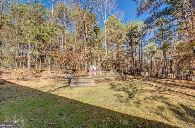 a view of yard with tall trees