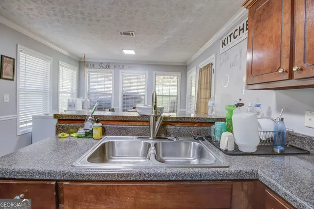 a kitchen with sink and window