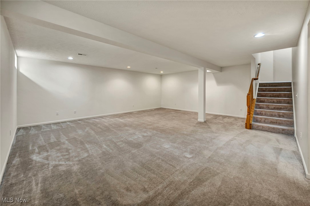 143 Stone Ridge Way Berea, OH 44017 - Photo 23 of 47 Finished basement with light carpet, stairway, and recessed lighting