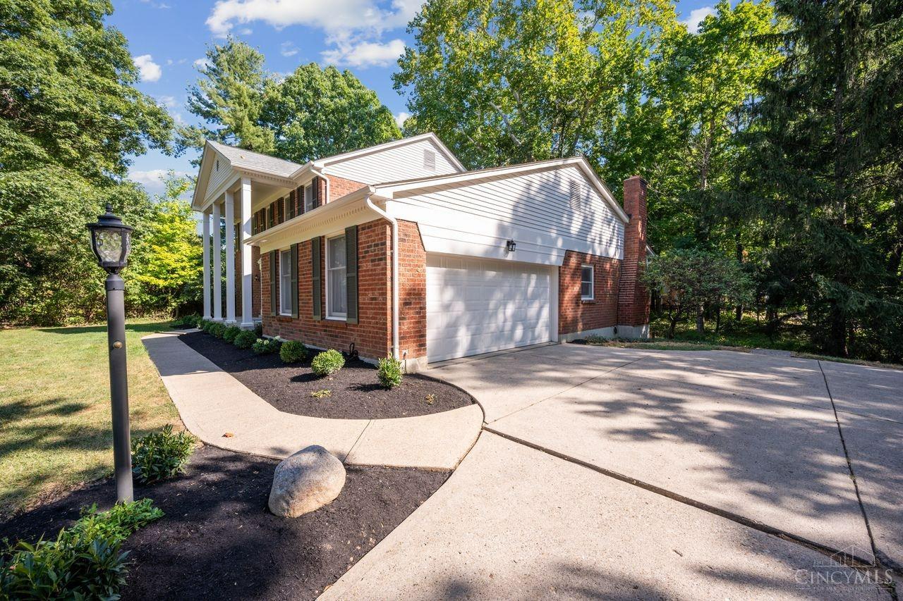 8589 Weller Road Montgomery, OH 45249 - Photo 29 of 30 The property includes a large parking apron, a double car garage, and a Tesla charging station. Montgomery's convenient walking trail/biking trail is located just across the street. It connects to Weller Park and the downtown business district.
