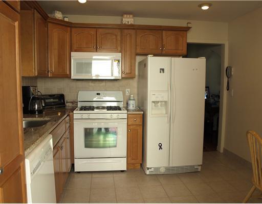 97 Pemberwick Road Greenwich, CT 06831 - Photo 3 of 6 a kitchen with a white cabinets and white appliances