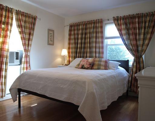 97 Pemberwick Road Greenwich, CT 06831 - Photo 4 of 6 a bedroom with a bed and a large window