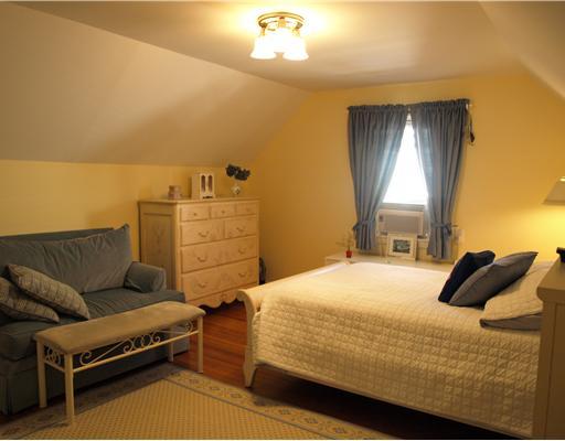 97 Pemberwick Road Greenwich, CT 06831 - Photo 5 of 6 a bedroom with a bed and a couch