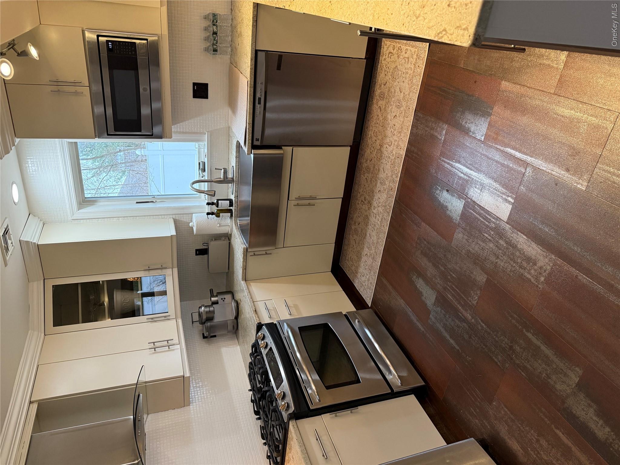 29 Wilton Road Rye Brook, NY 10573 - Photo 10 of 18 Kitchen with a sink, ventilation hood, dishwashing machine, range, and dark wood-style flooring