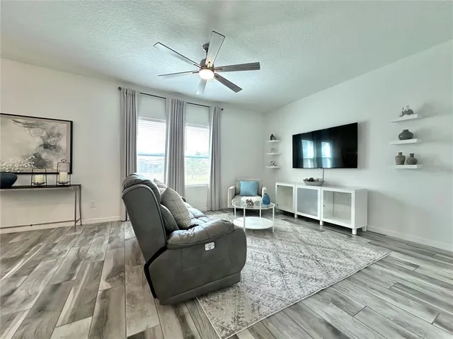 a living room with furniture a dining table and a fireplace