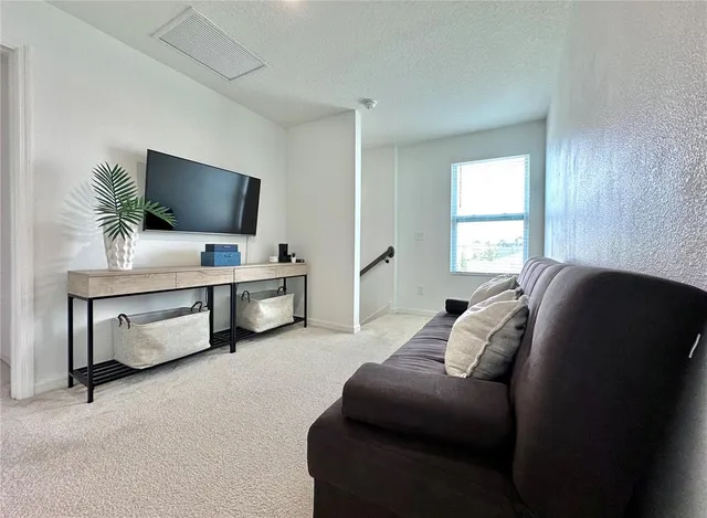 a living room with furniture and a large window