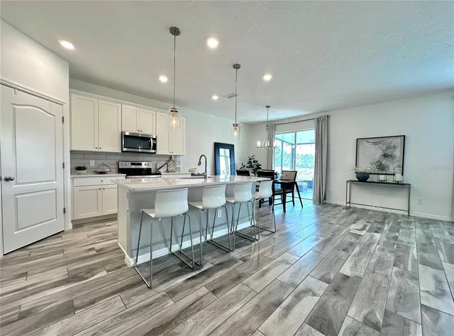 a kitchen with stainless steel appliances a refrigerator stove microwave and cabinets