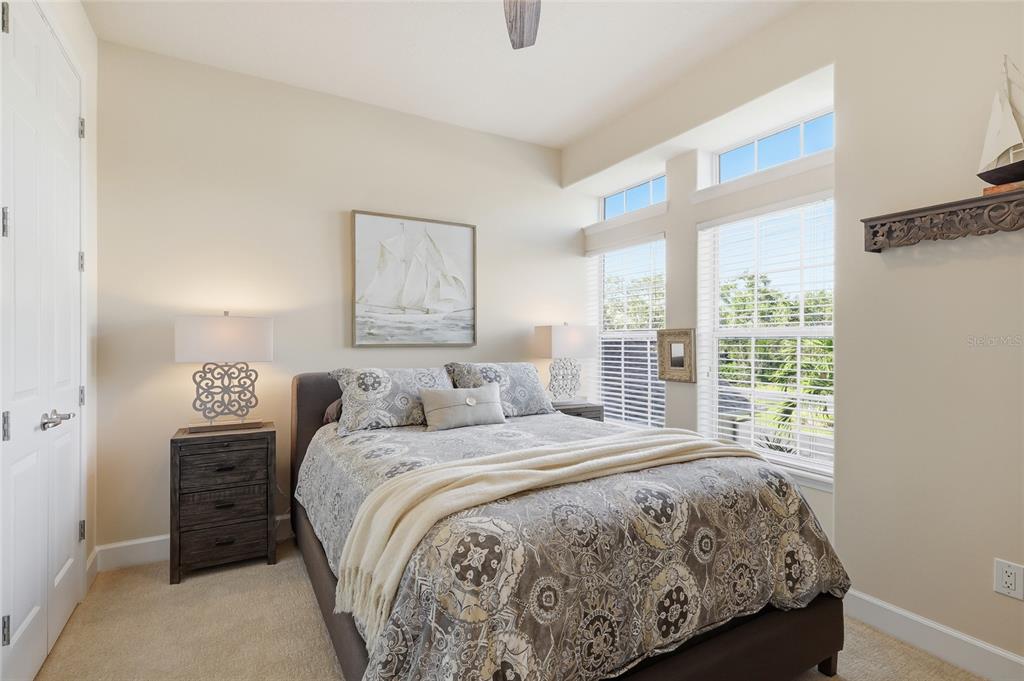 8063 St Simons Street, Unit 8063 University Park, FL 34201 - Photo 19 of 29 a bedroom with a bed and a large window