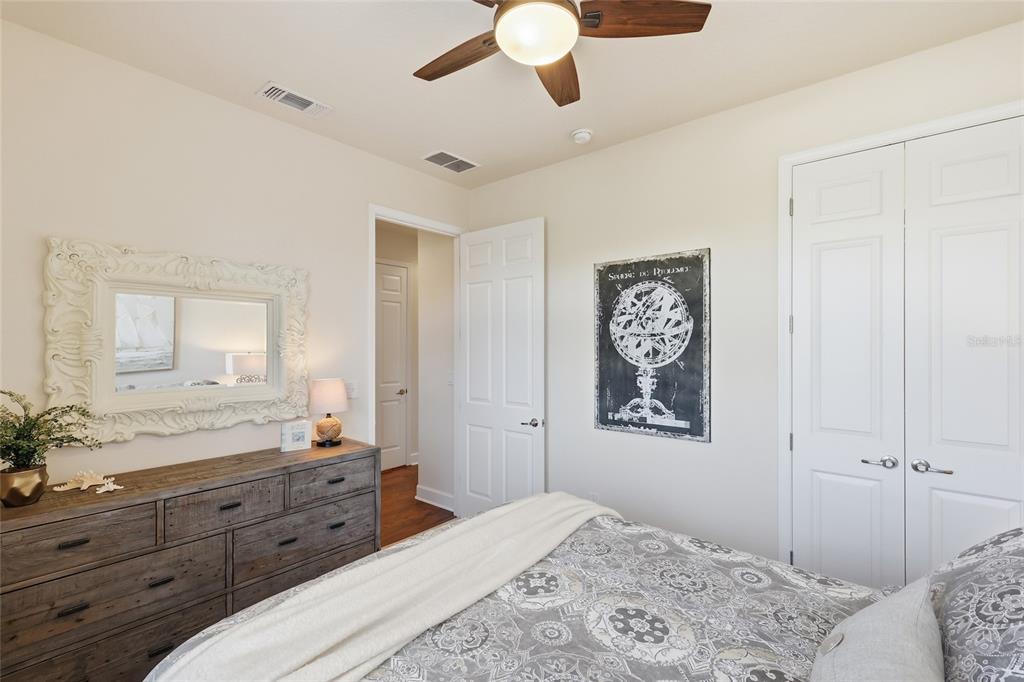8063 St Simons Street, Unit 8063 University Park, FL 34201 - Photo 20 of 29 a bedroom with a bed and a chandelier