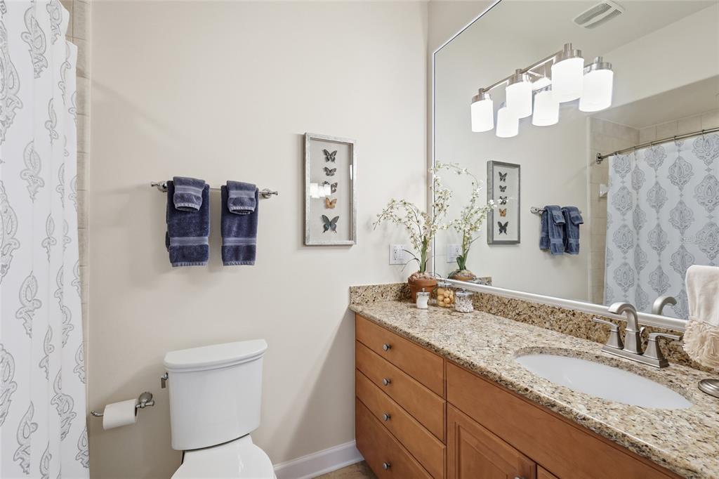 8063 St Simons Street, Unit 8063 University Park, FL 34201 - Photo 21 of 29 a bathroom with a granite countertop sink mirror vanity and toilet