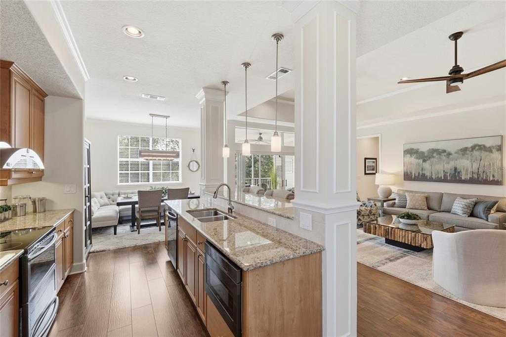 8063 St Simons Street, Unit 8063 University Park, FL 34201 - Photo 6 of 29 a kitchen with stainless steel appliances granite countertop a lot of counter space and a large window