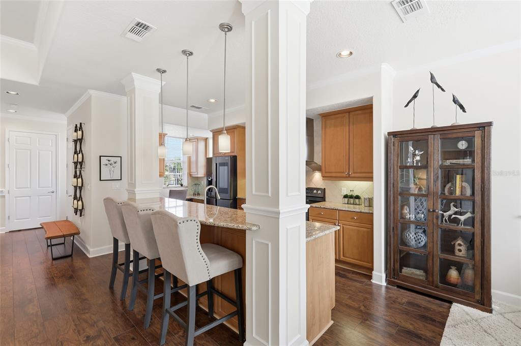 8063 St Simons Street, Unit 8063 University Park, FL 34201 - Photo 8 of 29 a view of a dining room and livingroom with furniture wooden floor a chandelier