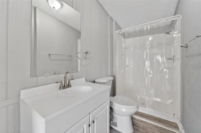 a bathroom with a sink toilet and shower