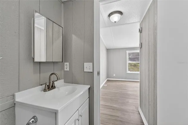 a bathroom with a sink and mirror