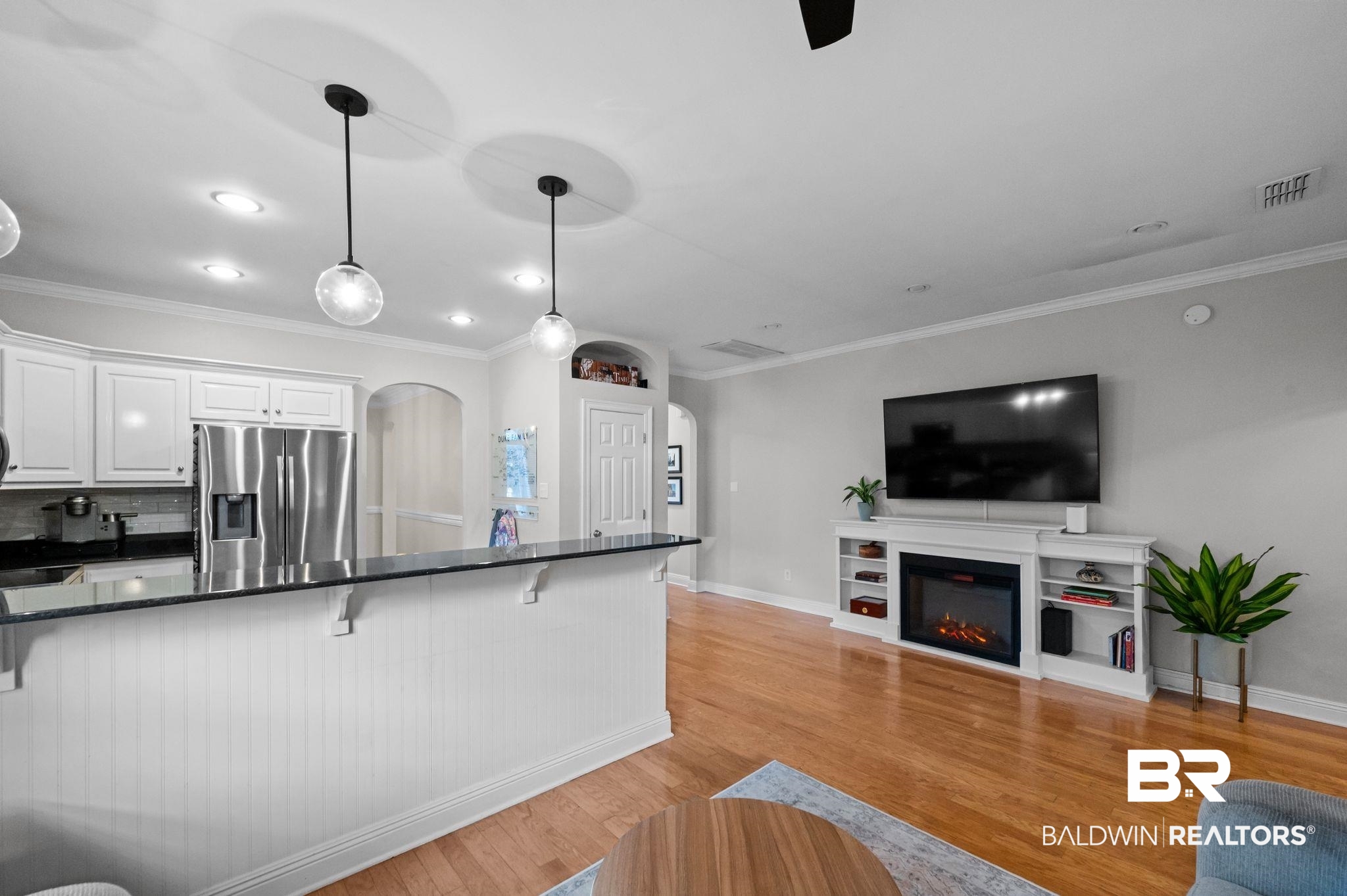 1825 Spring Hill Avenue Mobile, AL 36607 - Photo 42 of 43 Kitchen featuring a kitchen breakfast bar, dark stone counters, white cabinetry, arched walkways, and open floor plan