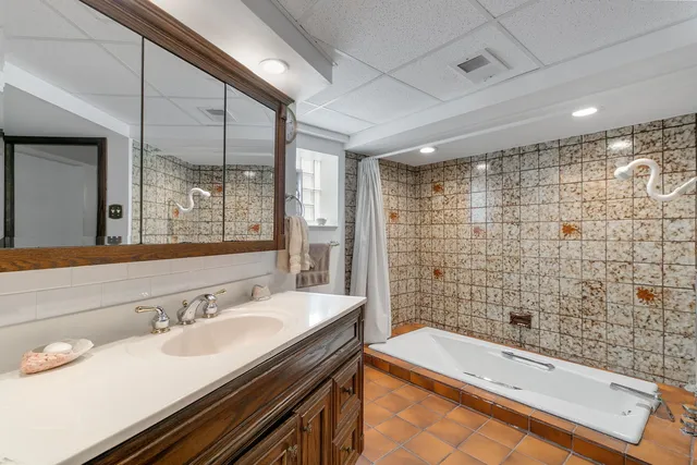 a bathroom with a bathtub and a sink